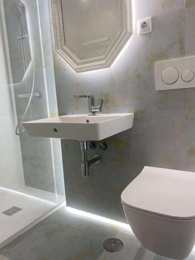 Sala de baño reformada con dos tipos de azulejo porcelánico